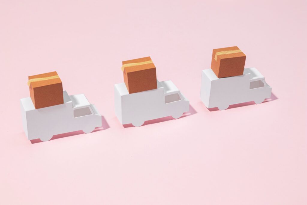 Paper trucks with moving boxes in the concept of 'How to Choose the Best Home Removals Company '.