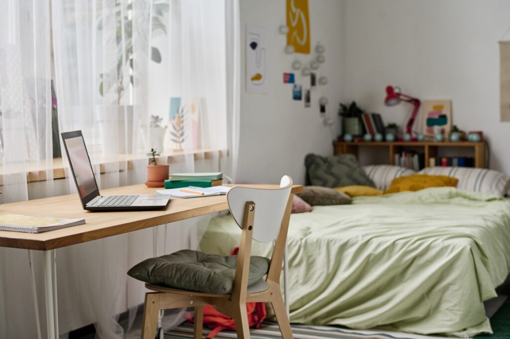 A dorm room with lots of belongings to organise